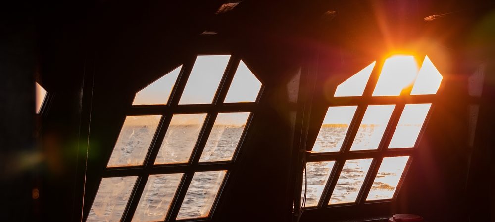 view of sunset from the cabin of a sailboat