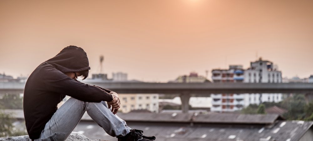 young man sitting on a roof
